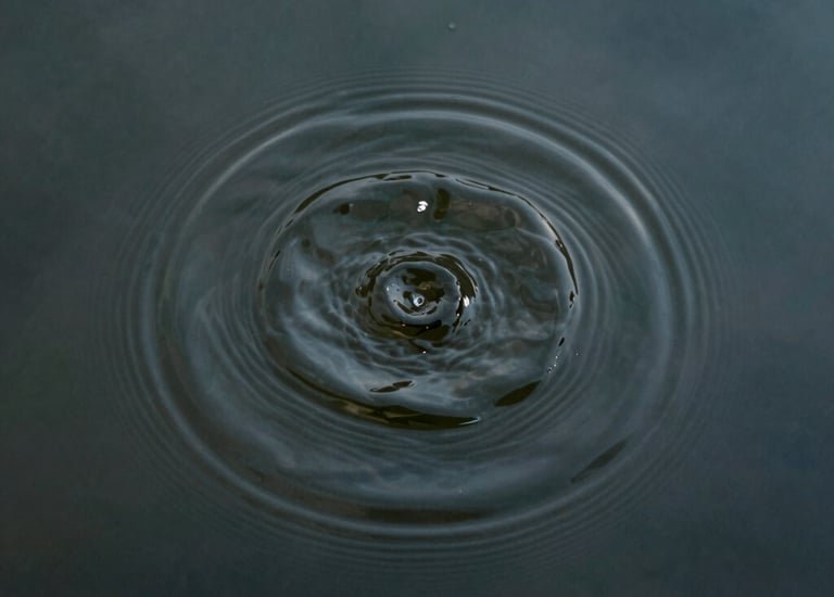 Stack of books on a wooden table with warm natural light.