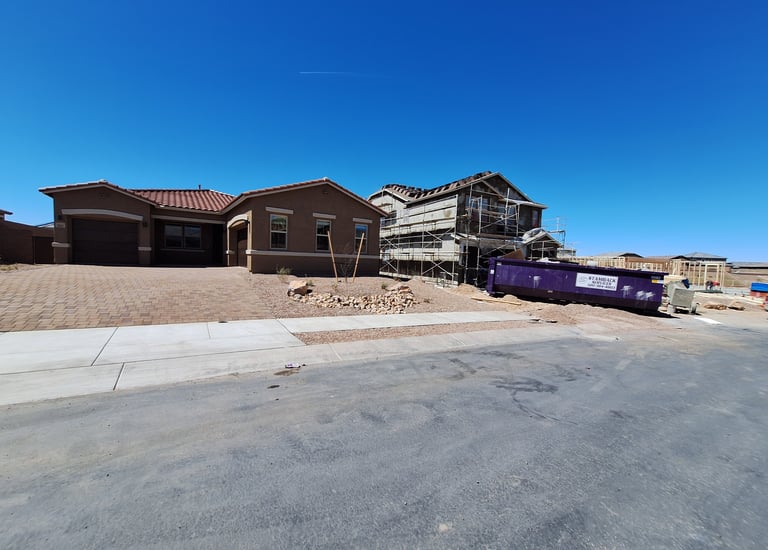 a dumpster truck parked in front of a house