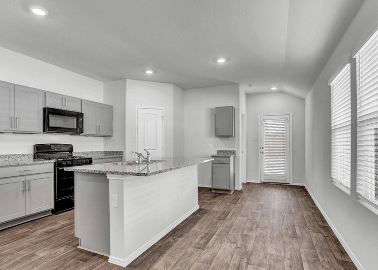 a kitchen with a stove top oven and a microwave