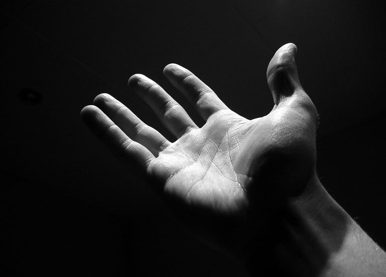 a person holding their hand out away from the camera