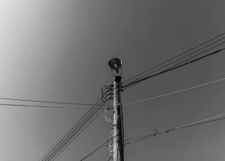 a telegraph pole with lots of communication wires