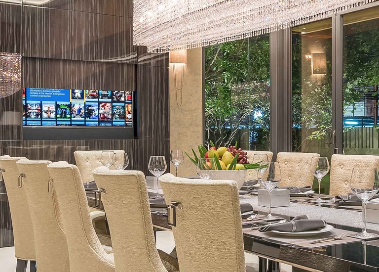 Large TV hidden behind a motorised wall panel with screen advance forward