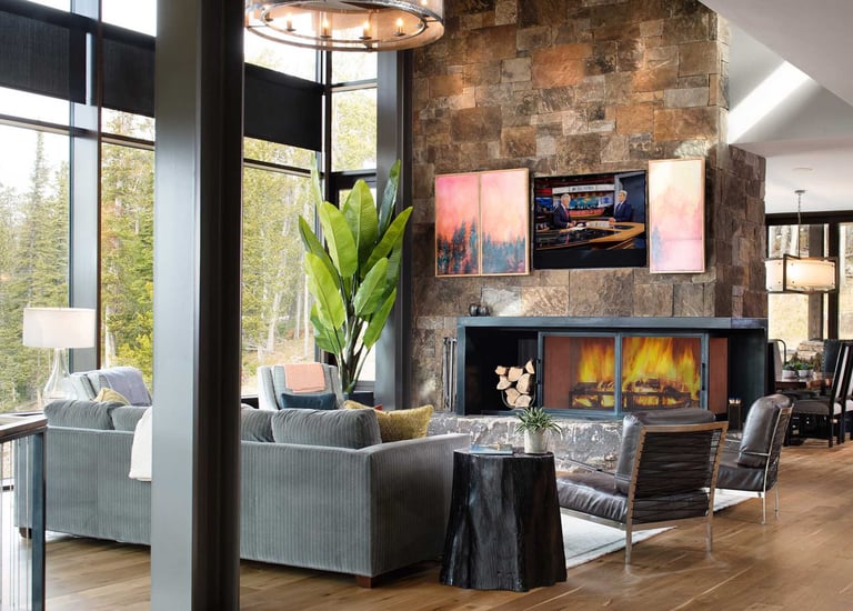 TV hidden behind a split moving panel with artwork