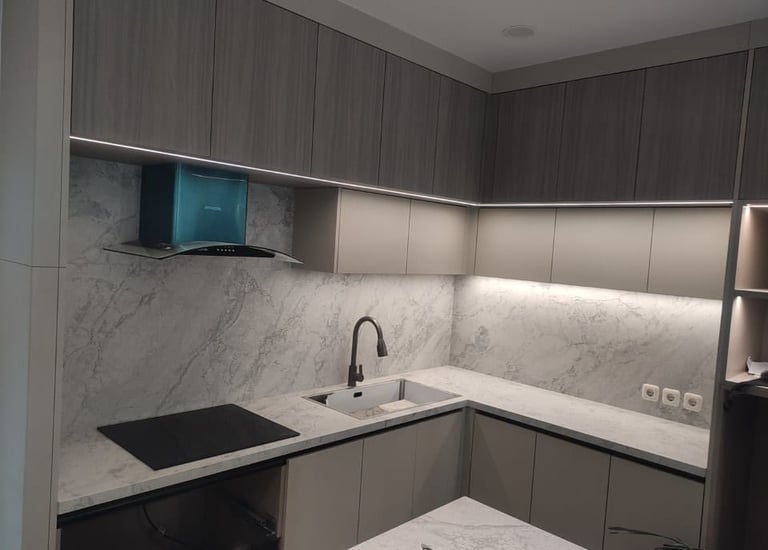 a kitchen with marble counter tops and a sink