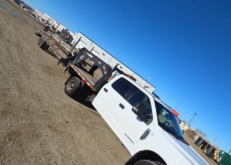 A truck with a gooseneck trailer getting ready for its next hotshot trip