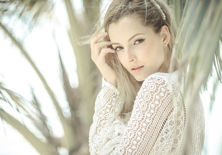 Portrait a woman in a white lace dress and a white lace top