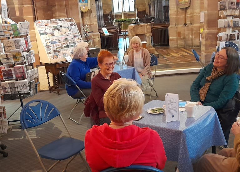 Customers enjoying fairtrade tea and coffee served by volunteers at Traidpoint Halesowen.