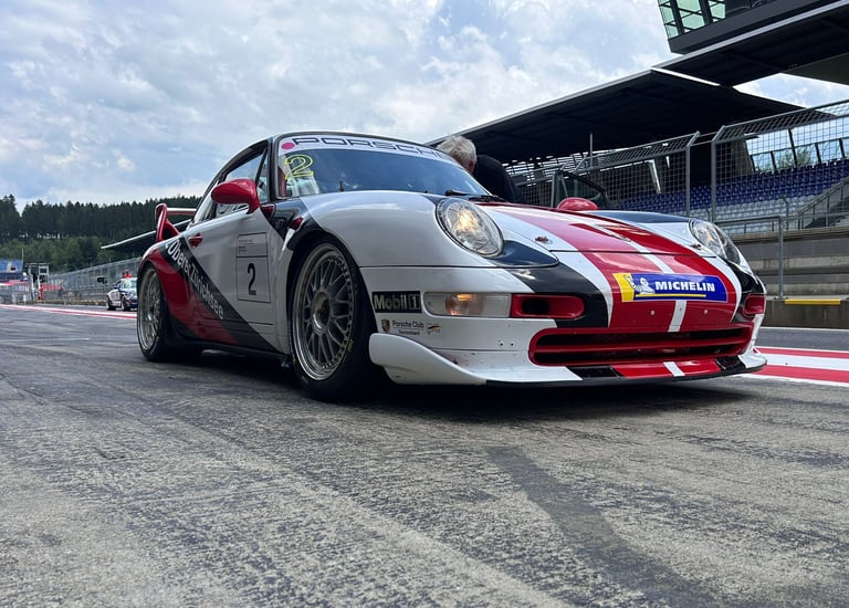 an Enlab Porsche sports car with a red and white stripe on it