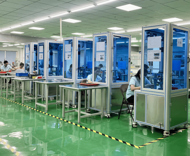 a factory floor with a lot of people working on machines