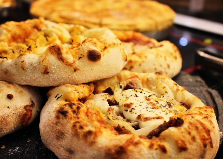a bunch of pizzas on a table