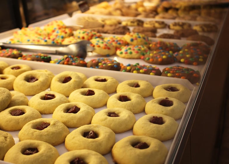 a tray of cookies and doughnuts on display