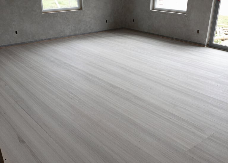 Construction team carefully smoothing new sidewalk surface with tools.