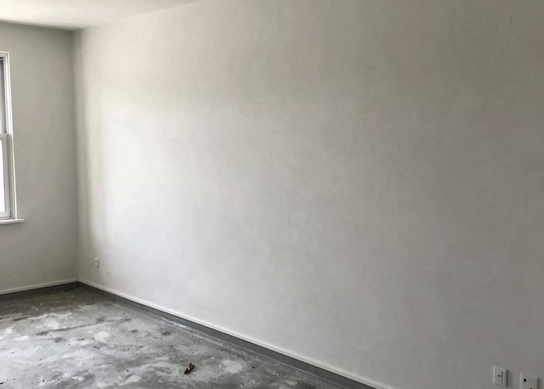 Modern commercial building under construction with visible concrete work and scaffolding.