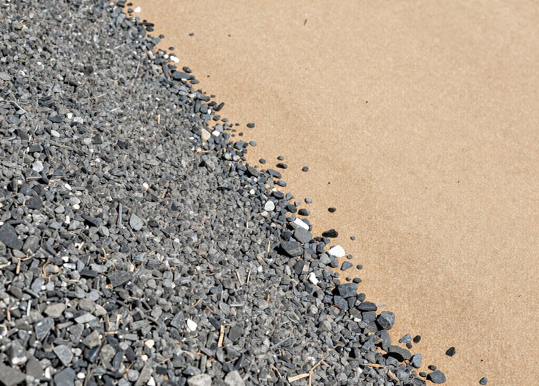Stacks of gravel ready for delivery at a commercial site.