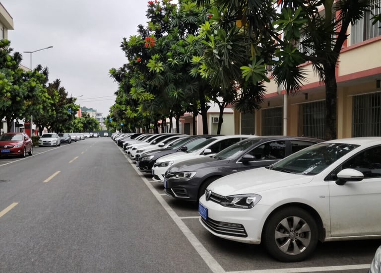 A disciplined security guard standing alert at a corporate building entrance during dusk.