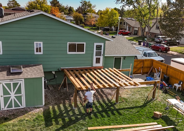 Drone view of overhead deck framing structure under construction by Brewer Construction in Denver