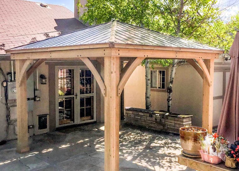 Completed custom wood pergola and integrated ceiling fan on a Denver, Colorado backyard patio.