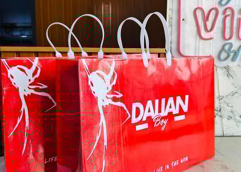 Close-up of vibrant custom paper bags with sleek logos in a modern office setting.