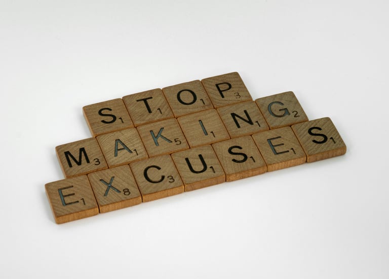 a wooden block with words that spell out the word stop making excuses