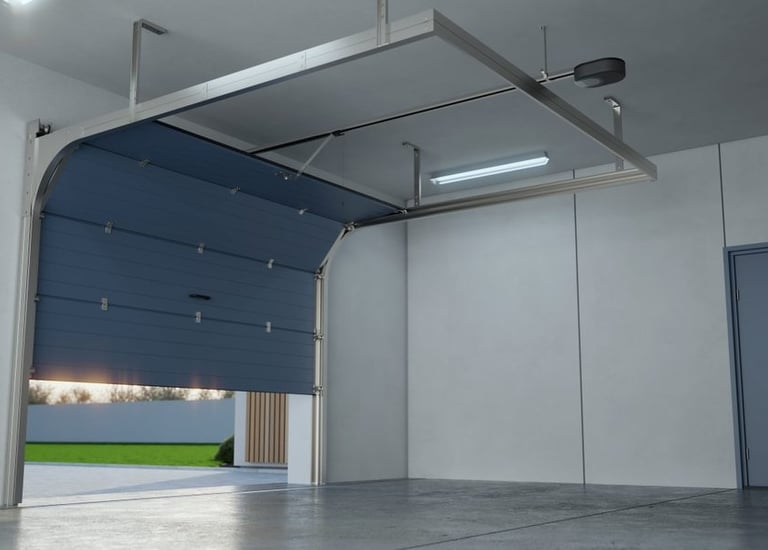 A modern, blue sectional garage door partially open in a clean, new garage, revealing an outdoor scene with green grass.