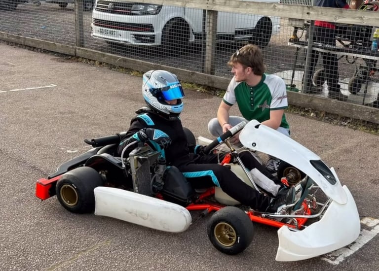 a man and a boy riding a go kart