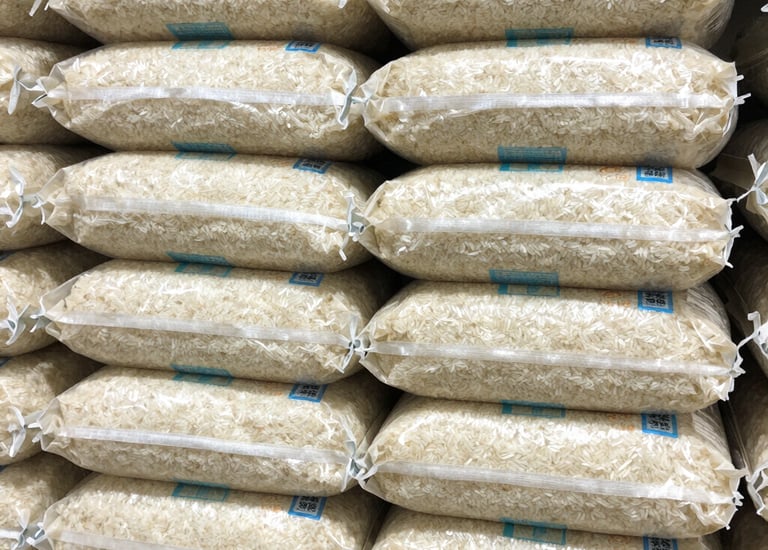 Close-up of authentic Thai jasmine rice bags neatly arranged on retail shelves.