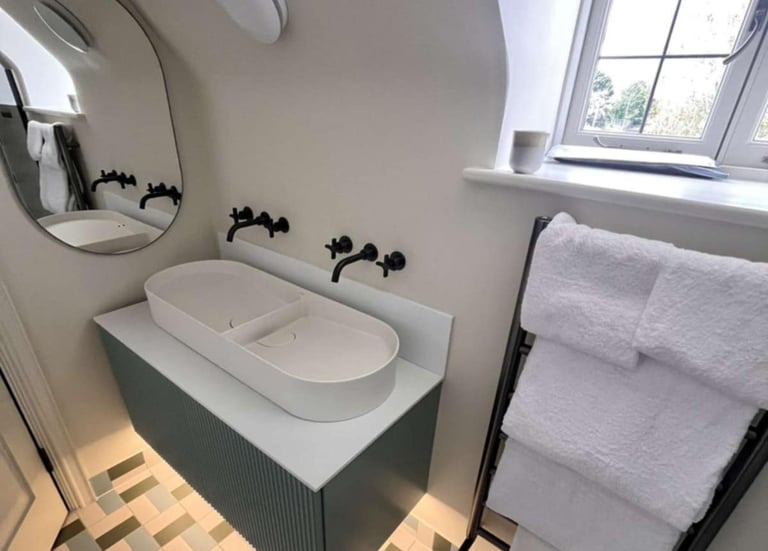 a bathroom with a bathtub and a mirror Bathroom with bathtub and wall mirror installed by PBP Servic
