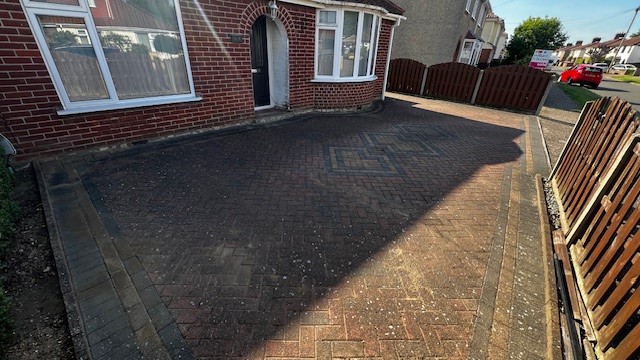 Removing dirt and stains from brick weave driveway with pressure washing in Norwich Norfolk