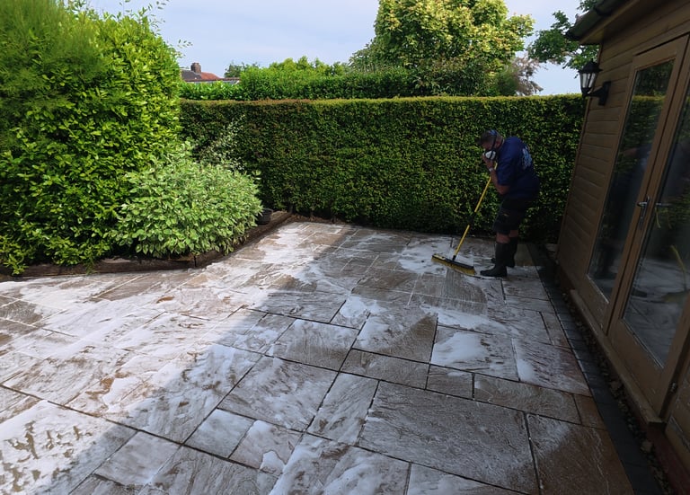 PJB Exterior Cleaning in Norwich, Norfolk applying chemical treatment and scrubbing Indian sandstone