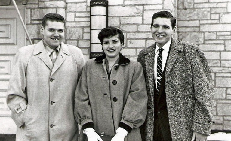two men and a woman standing next to each other