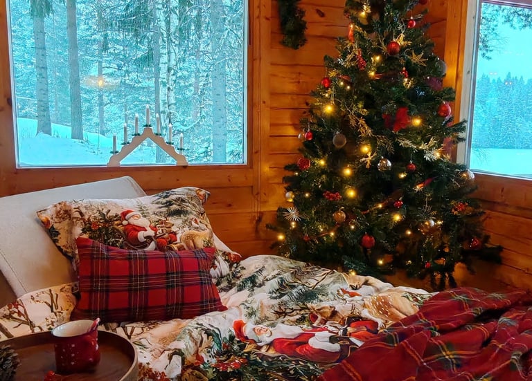 a bedroom with a christmas tree in the background