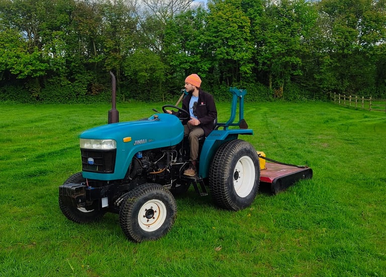 Compact tractor mowing