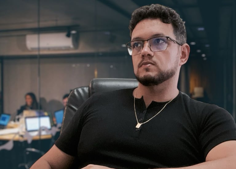 a man sitting at a desk with a laptop