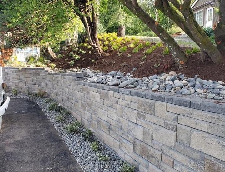Modern tiered block retaining wall for slope management and erosion control.