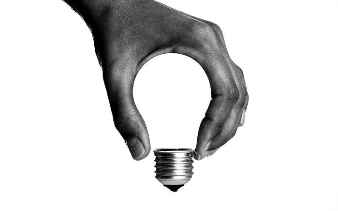 Creations and Solutions: a person holding a light bulb in their hand