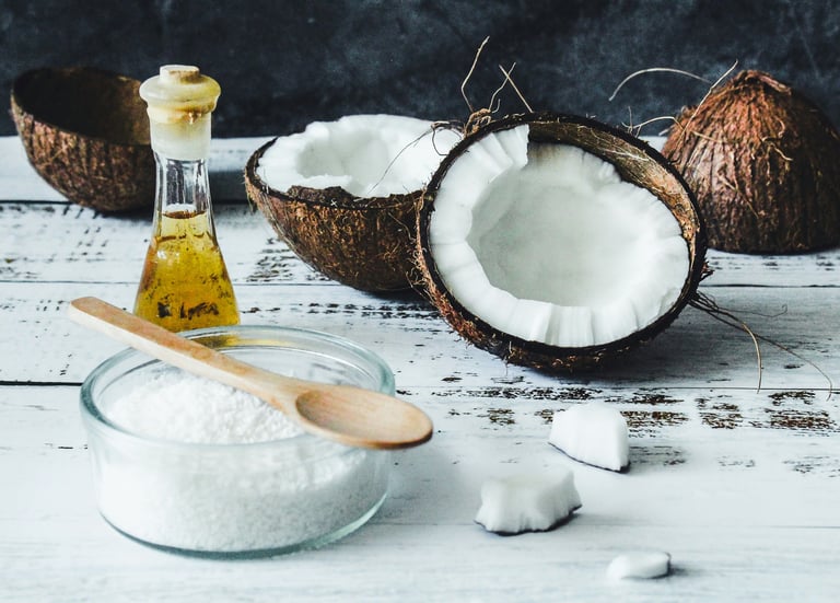 a coconut oil bottle with a wooden spoon and a wooden spoon with a wooden spoon