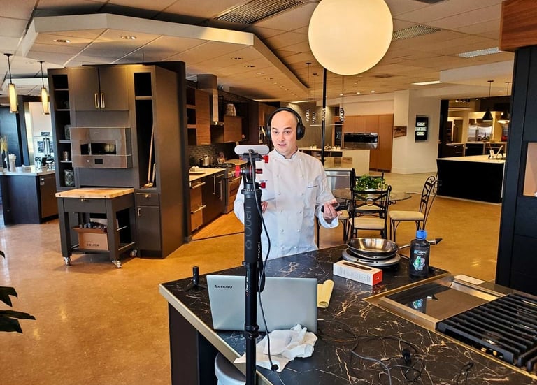 Chef Andrew Forlines in a retail home kitchen appliance showroom recording a video podcast episode.