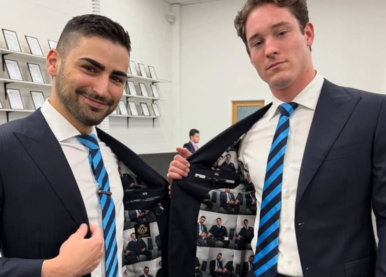 two men in suits and ties posing for a picture