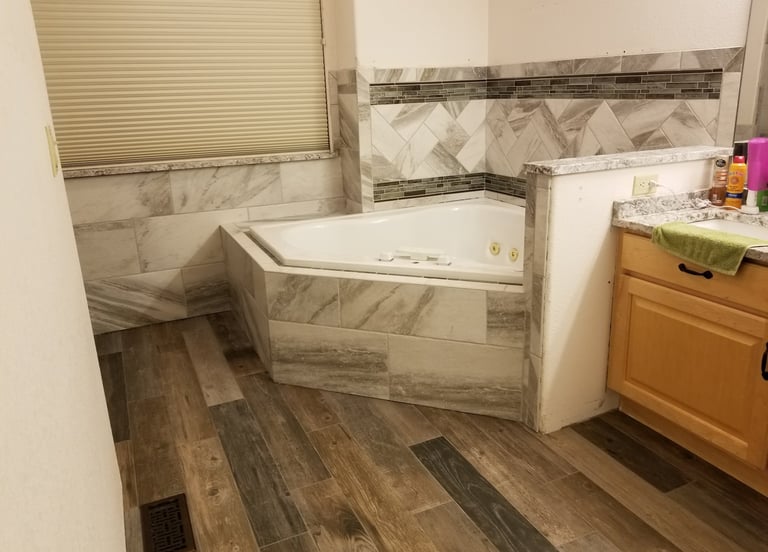 a bathroom with a tub tub and a shower
