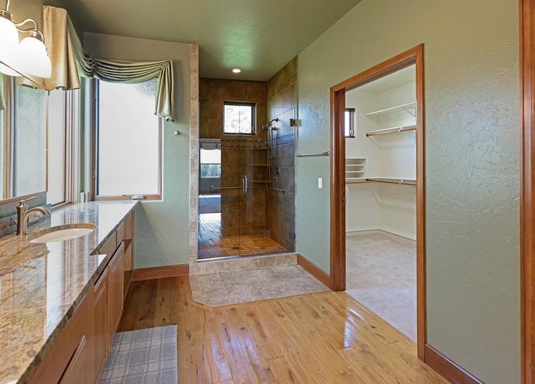 a bathroom with a large mirror and a shower