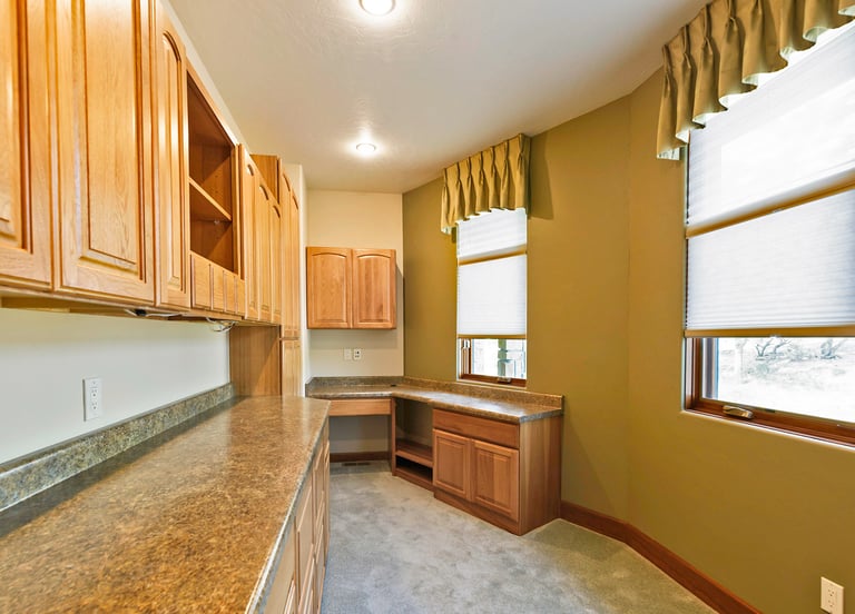 a office with a counter top and cabinets