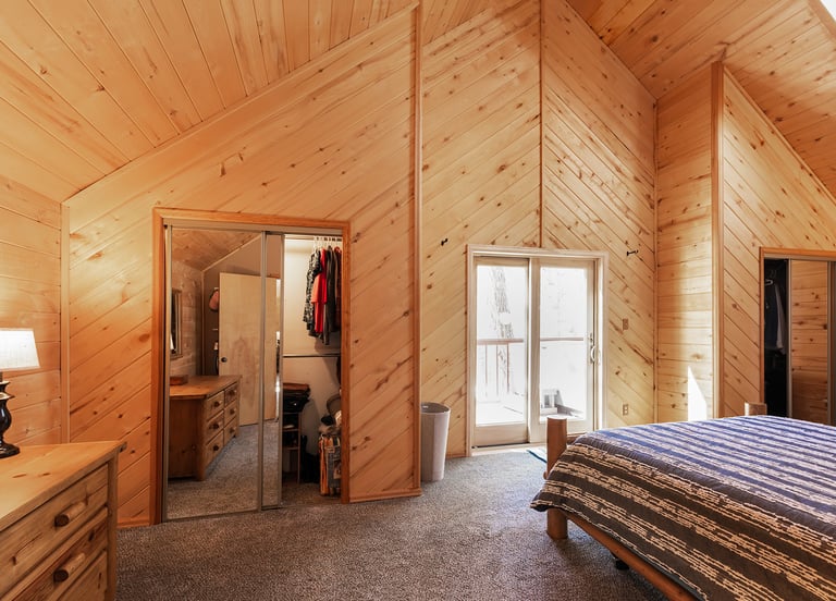 a bedroom with a bed and a bed in the corner