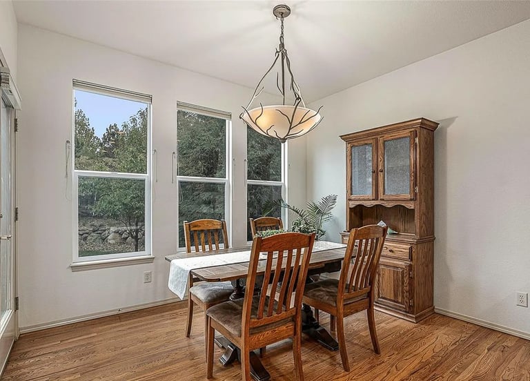 a dining room with a table and chairs