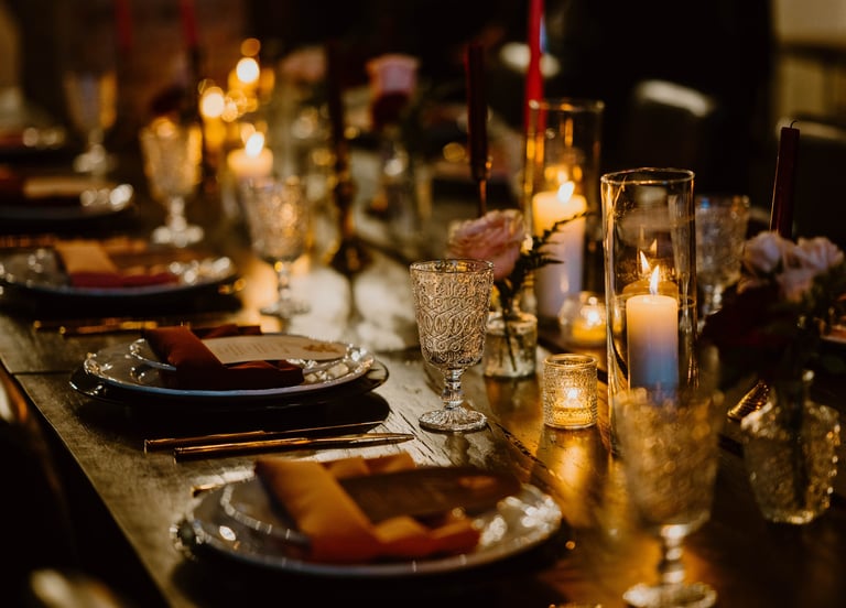 tablescape at chapel and cellar in winter park moody romantic with candles roses black chargers