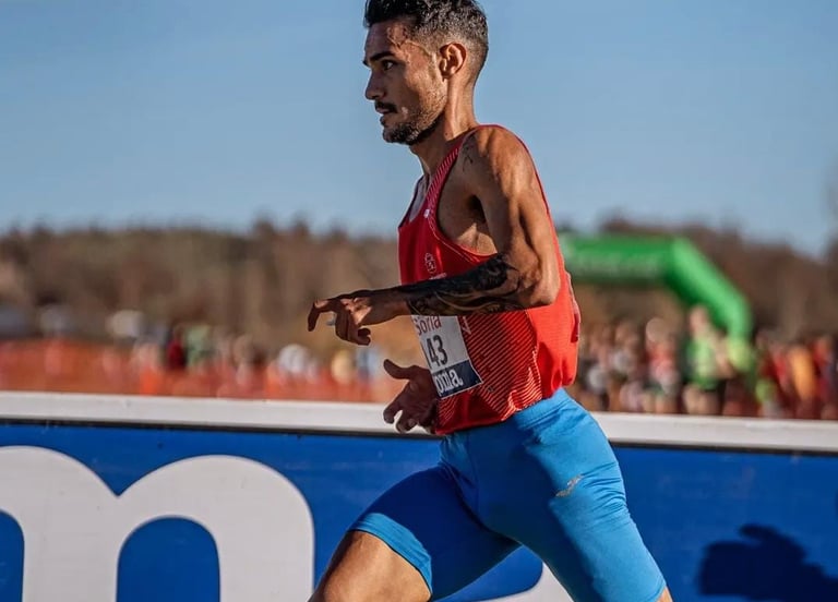 a man running in a race with a red shirt
