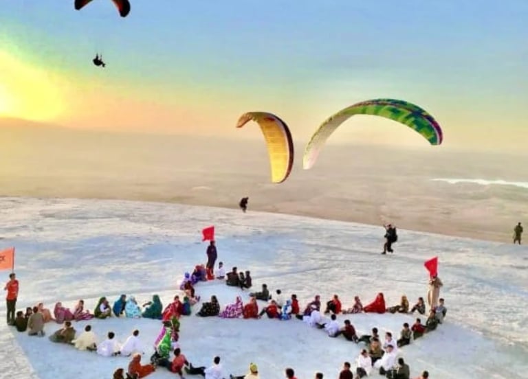 Children exploring the vibrant streets of Morocco, with paragliding pilots soaring above