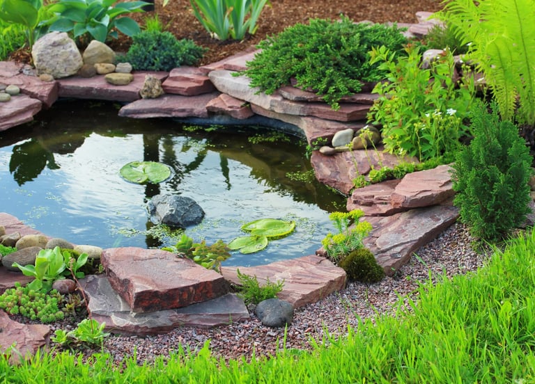 Custom garden pond with natural rock edging.