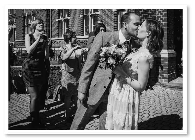 Groom kissing bride during a send off.