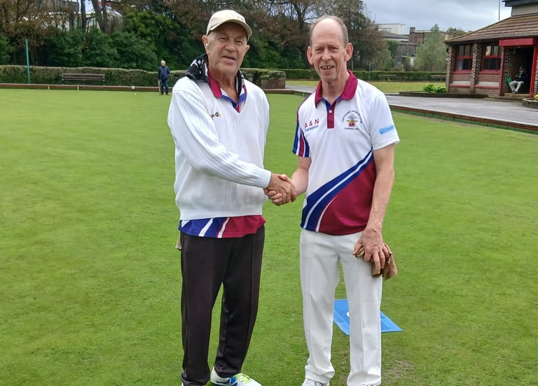 two Porthcawl bowls club players shaking hands before the start of a game