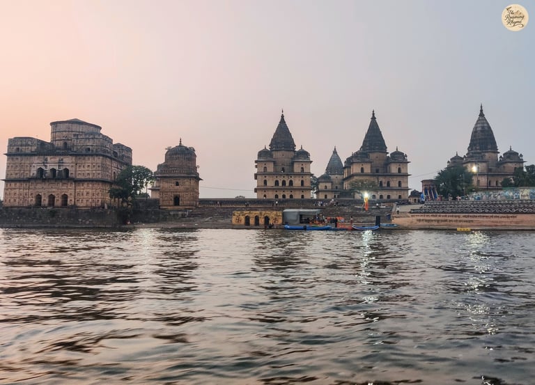 Scenic view of Orchha's royal cenotaphs from the Betwa River boat ride.